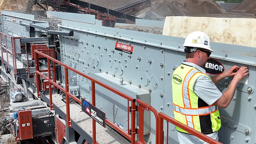 Aggregates worker collecting operating data from his horizontal screen