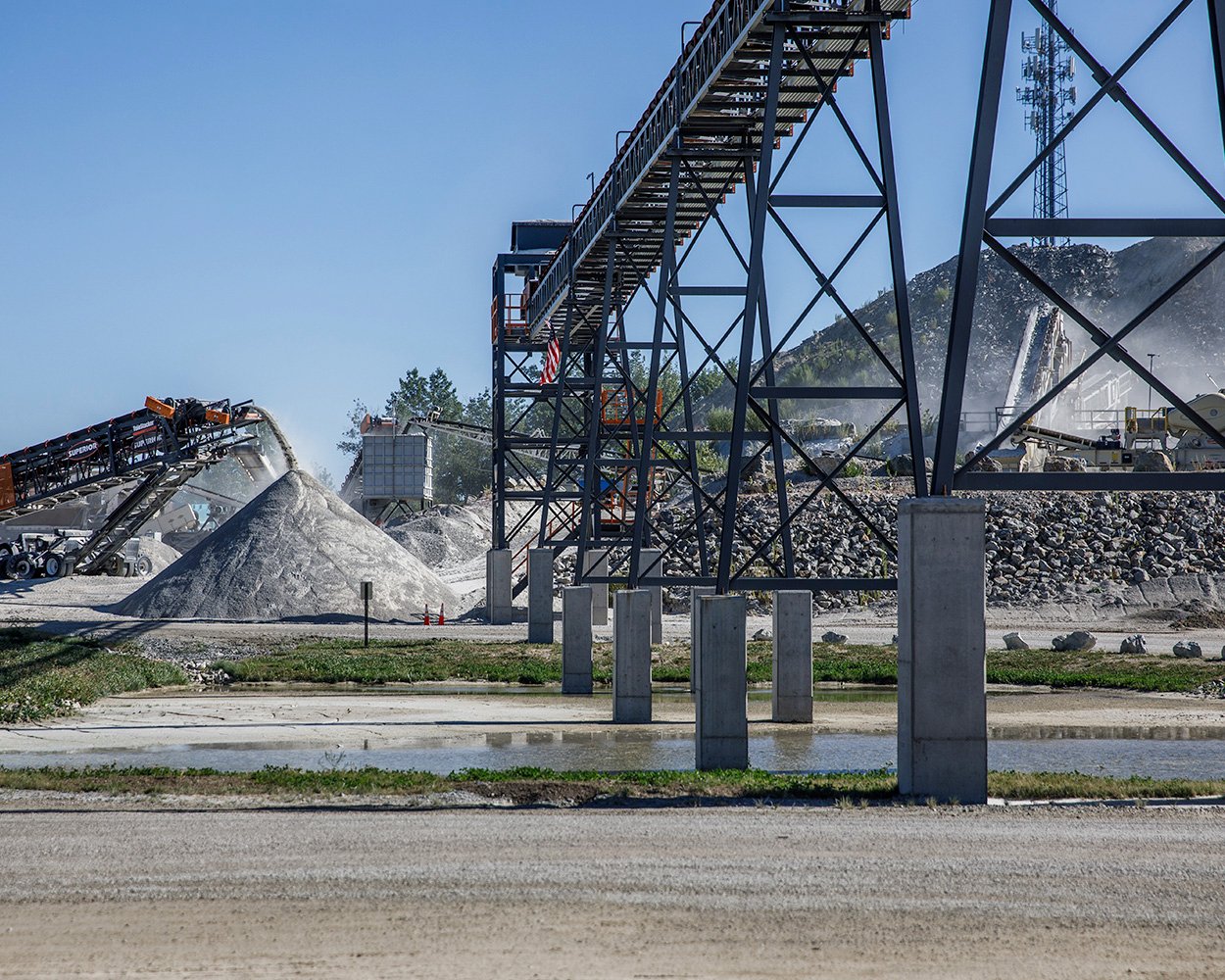 Overland conveyor transporting material across Onyx Corporation’s quarry, feeding stockpiles and supporting continuous plant production