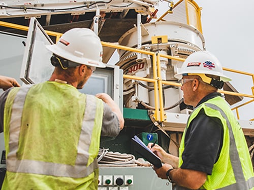 Technicians operating the Vantage® Automation system on a Patriot® Cone Crusher