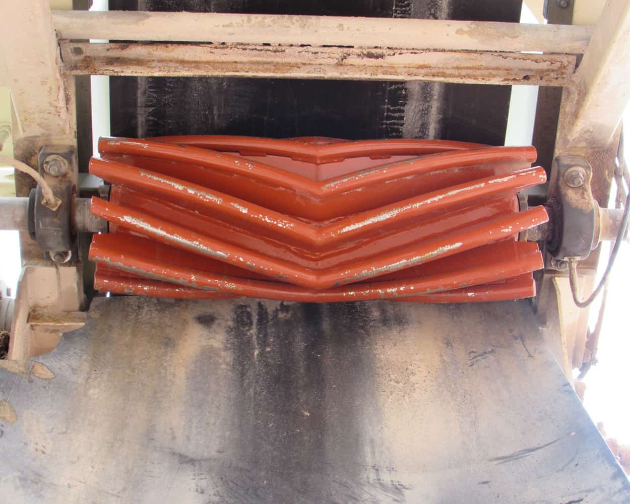 Chevron Wing Pulley installed on conveyor with view of pulley and belt.