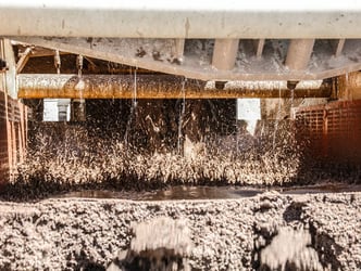 water splashing on closeup of wet screen deck washing aggregate sand