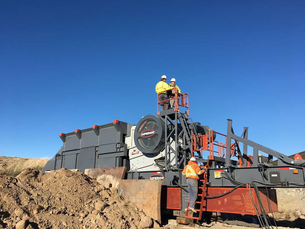 Portable Liberty Jaw Crusher plant with crew performing inspection at active aggregate site