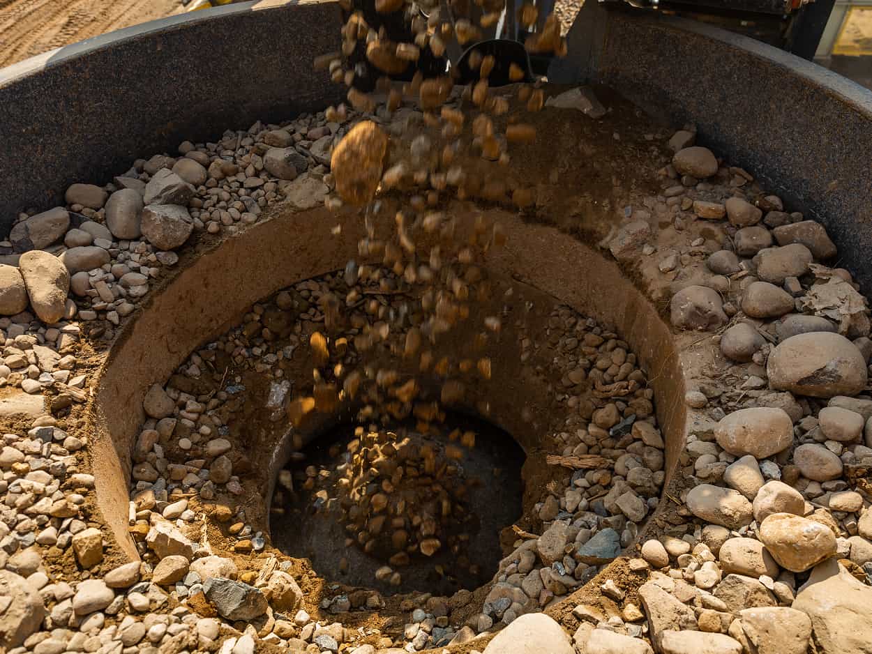Portable Superior Patriot Cone crushing plant at a job site with material feeding  into the cone.