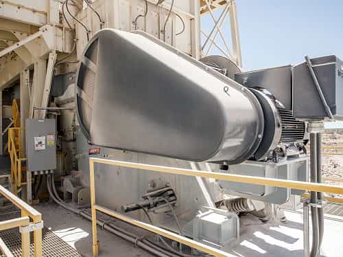 Liberty® Jaw Crusher in a primary crushing setup processing shot rock on a raised stationary quarry platform