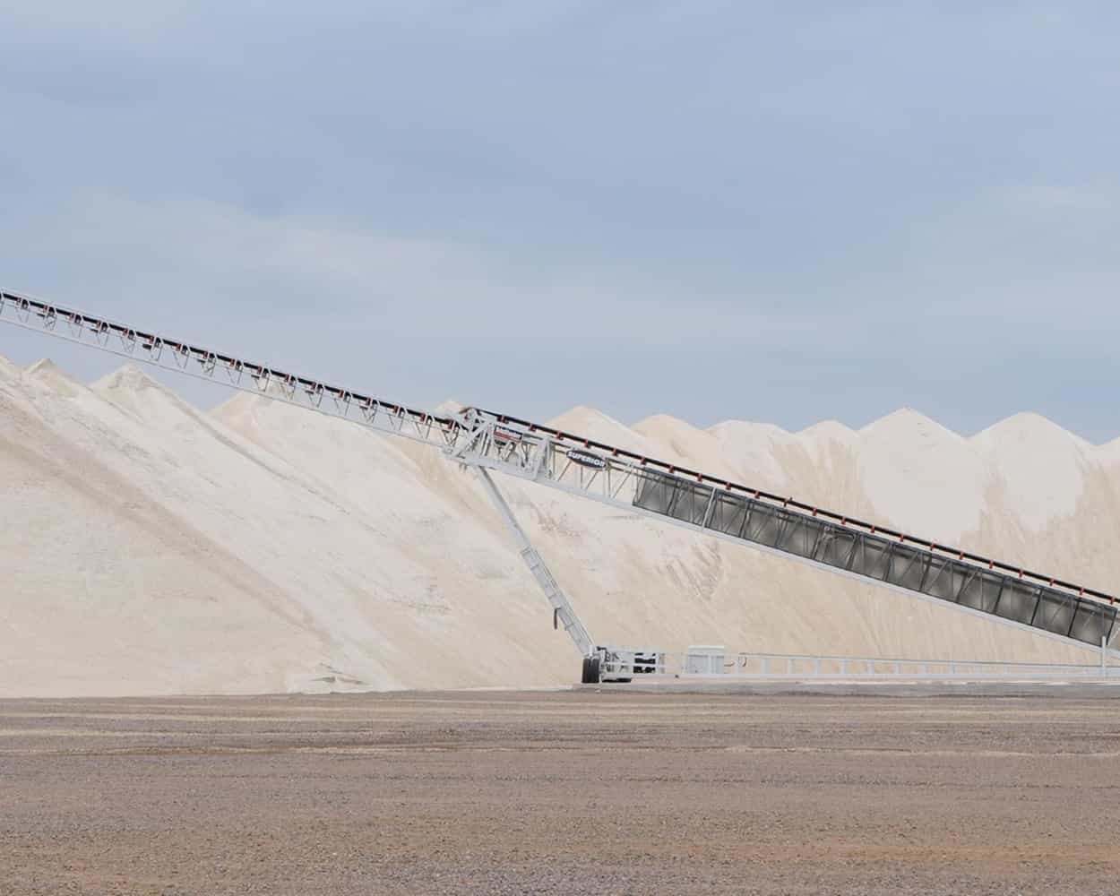 TeleStacker® Conveyor fully extended stockpiling sand and aggregate at quarry site
