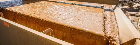 closeup of wash water at top level of aggregate washer processing sand