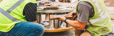 two workers at CO site doing maintenance inspection on vsi crusher