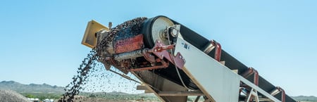 Exterra® Dual Belt Scraper on head of conveyor  discharging material