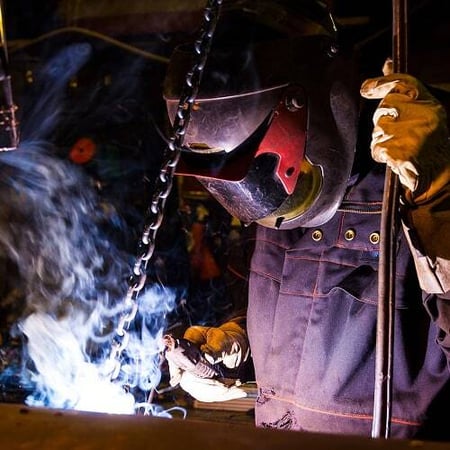 A welder fabricates metal components under bright sparks, symbolizing Superior’s hands-on control and in-house manufacturing
