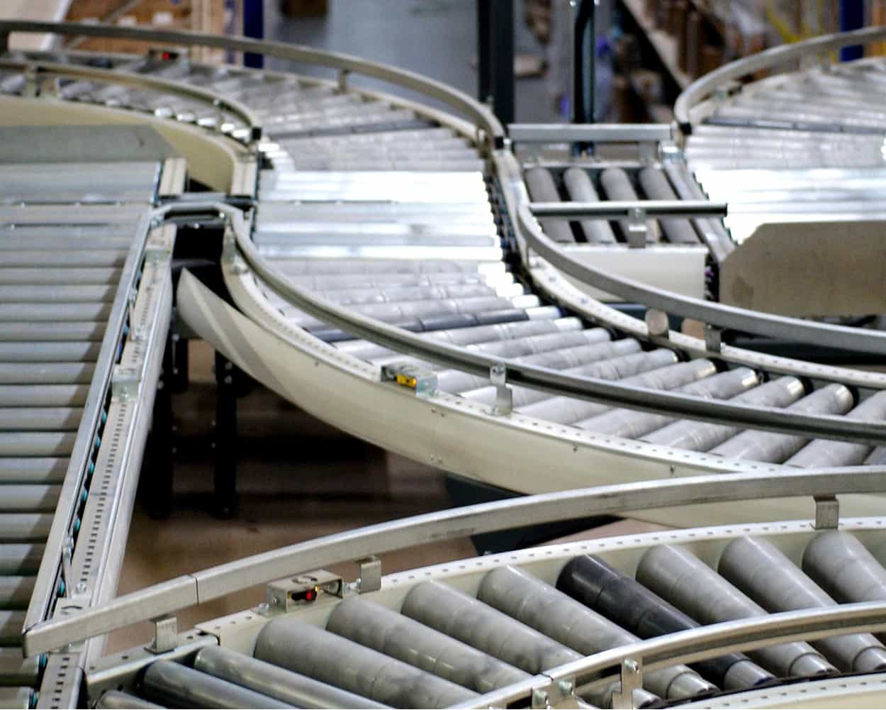 Curved roller conveyor system from Superior Industries in a unit handling facility