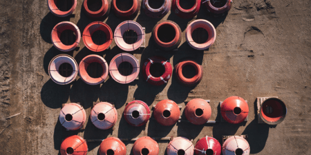 drone view of cone crusher parts organized in outdoor warehouse yard