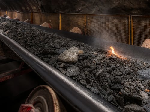 Small fire starting on a conveyor belt