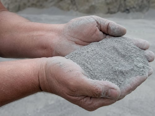 Quarry employee holding aggregate fines that were removed during the washing process.