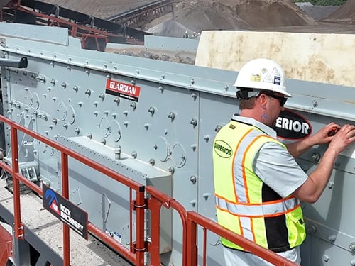 Aggregates worker collecting operating data from his horizontal screen
