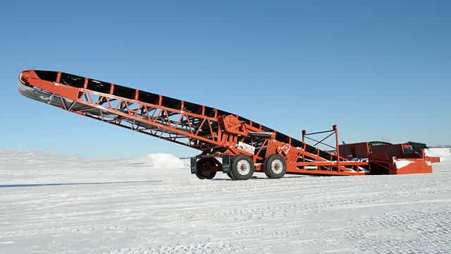 Superior® RazerTail® Truck Unloader positioned on a snowy test pad, designed for clean and efficient truck unloading and material transfer.