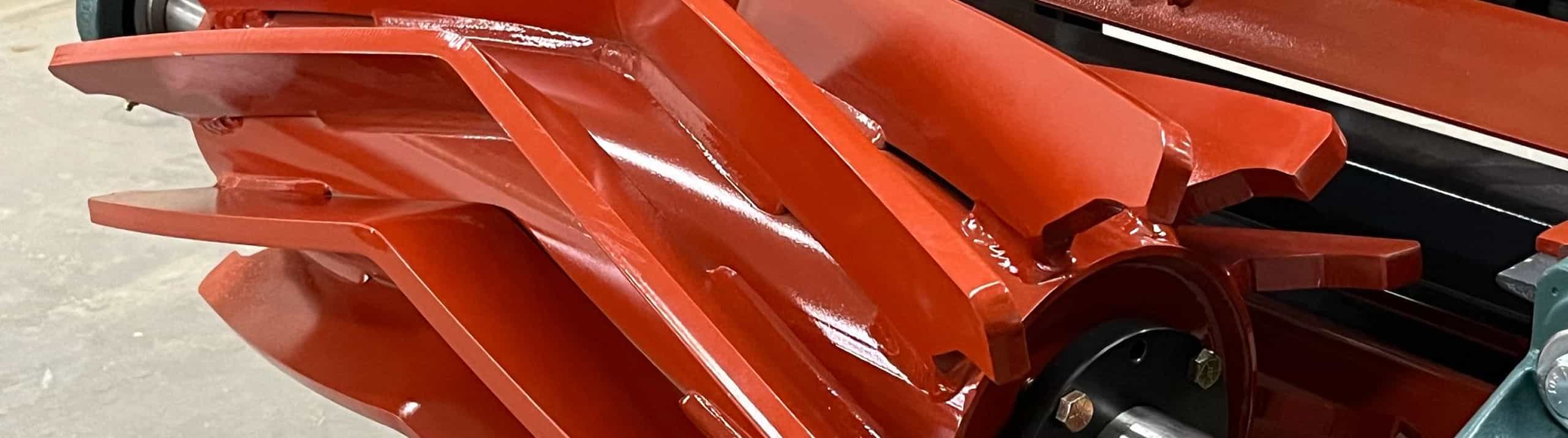 closeup of capless Chevron Wing Pulley on display conveyor without a belt