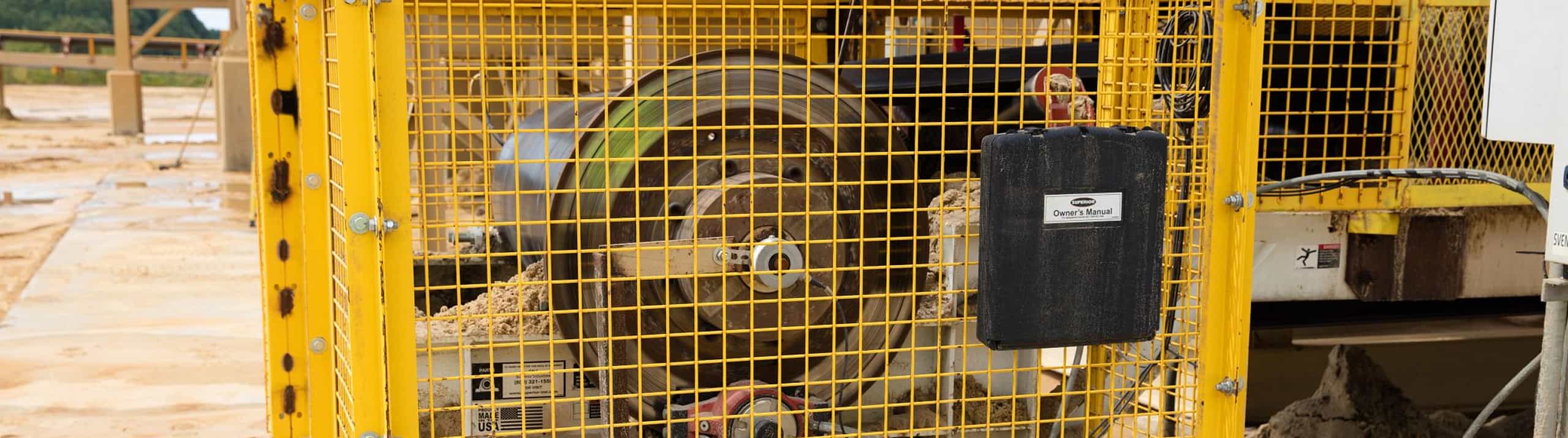 Core system drive design enclosed in safety guarding on site of aggregates operation