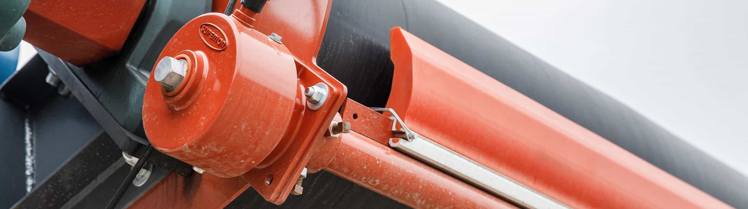 Closeup of Exterra Primary Belt Cleaner, belt scraper with click tensioner on tail end of aggregate conveyor