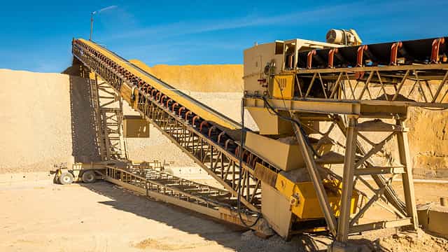 Superior® Stationary Stacker moving aggregate material at a quarry site, designed for long-term bulk stockpiling.