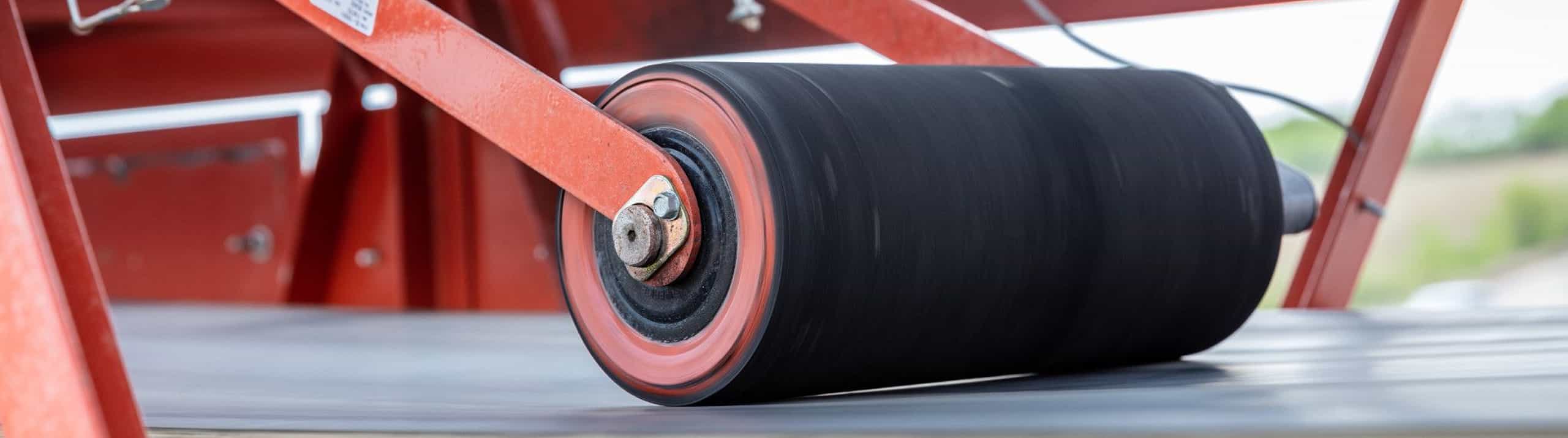 Closeup of speed sensor on clean side roll of conveyor in operation