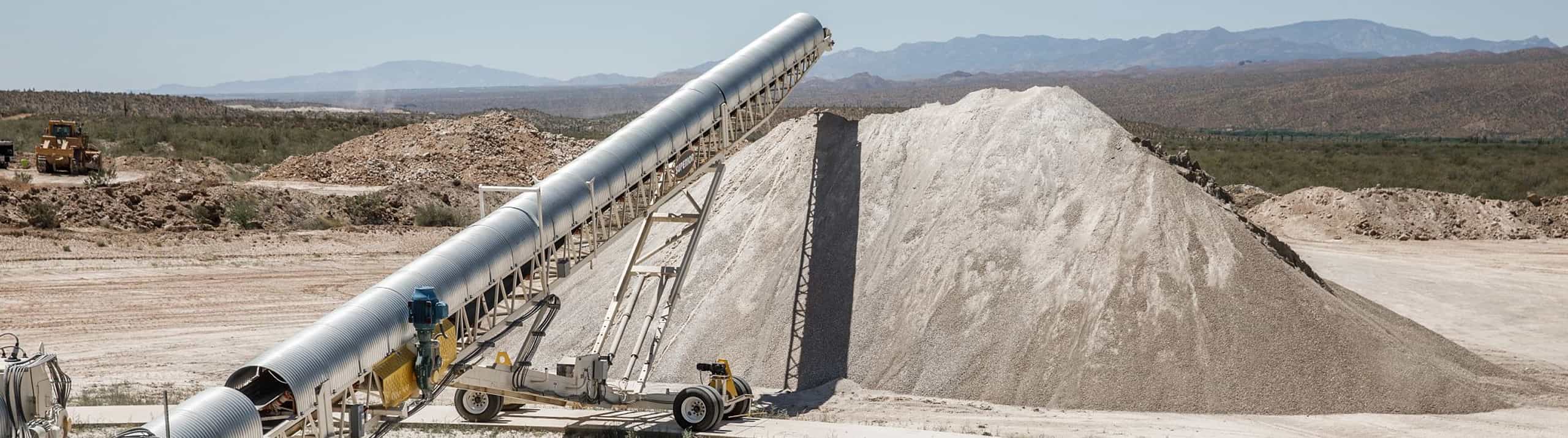 Belt cover sections enclosing conveyor belt on a Portable Radial Stacking Conveyor at a mining site