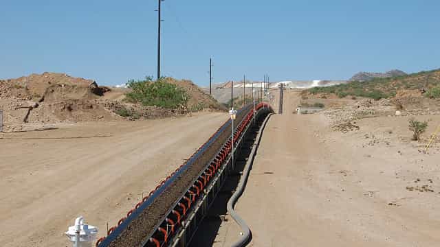 Superior® Stationary Transfer Conveyor transporting material over long distances at an open-pit mining site.