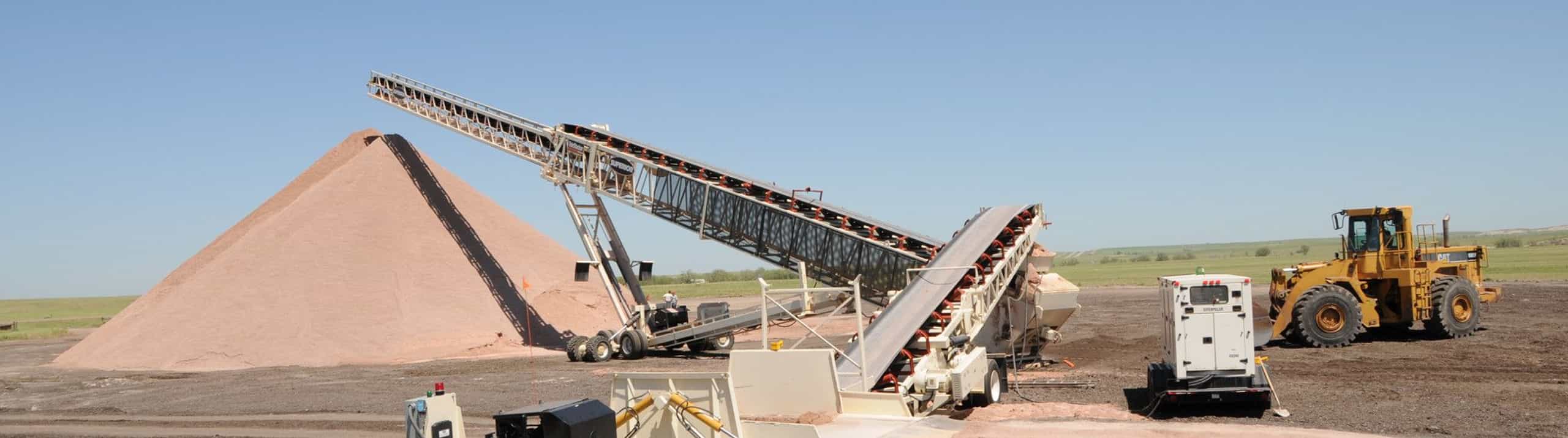 RazerTail® Truck Unloader feeding aggregate to the tail end of a TeleStacker® Conveyor