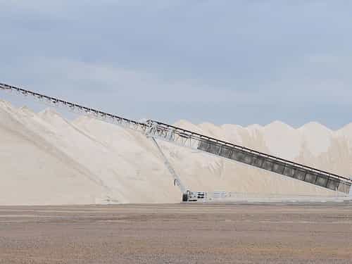 TeleStacker® Conveyor fully extended stockpiling sand and aggregate at quarry site